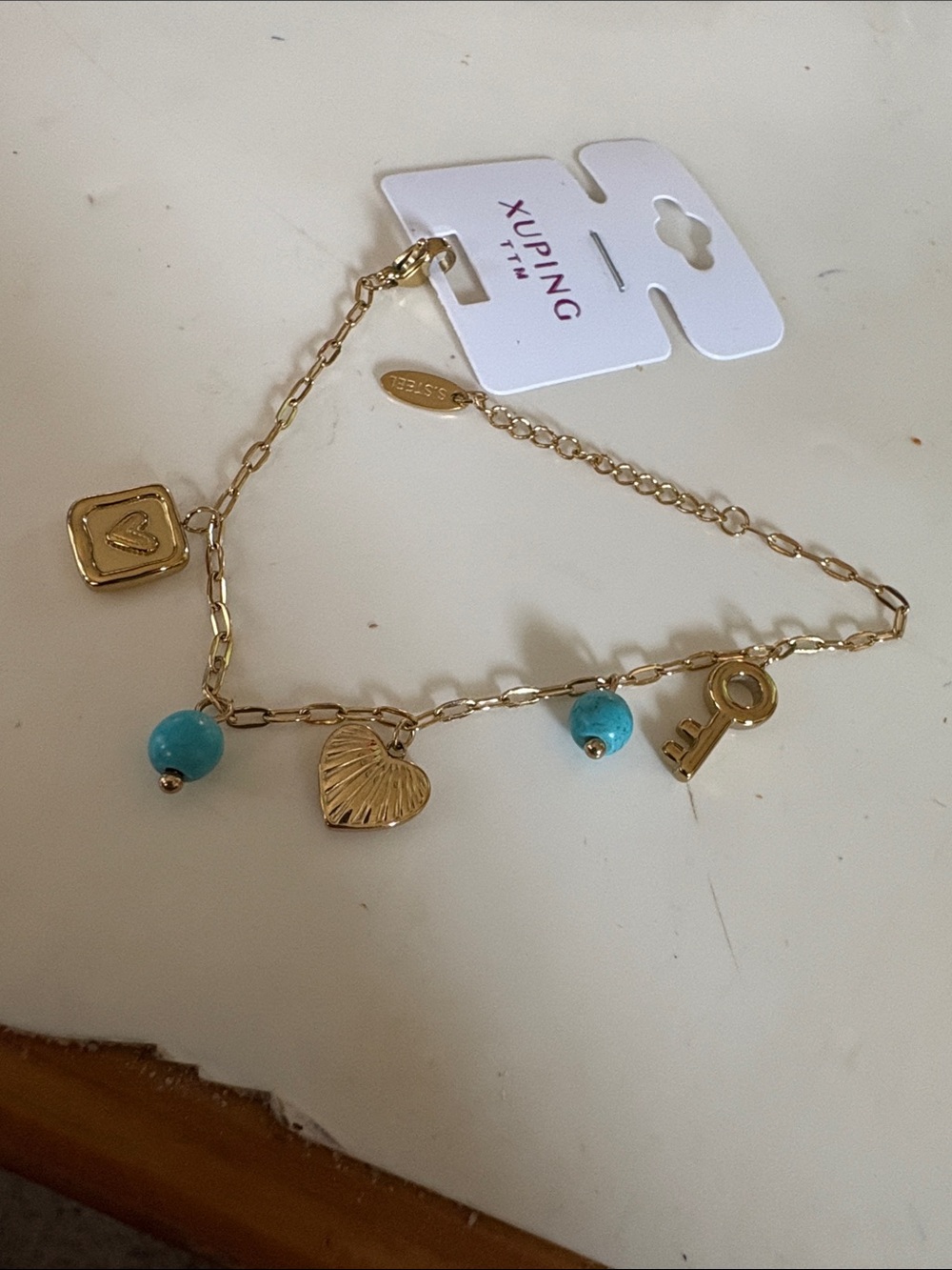 Ping Gold-Tone Charm Bracelet with Turquoise Beads and Key Charm